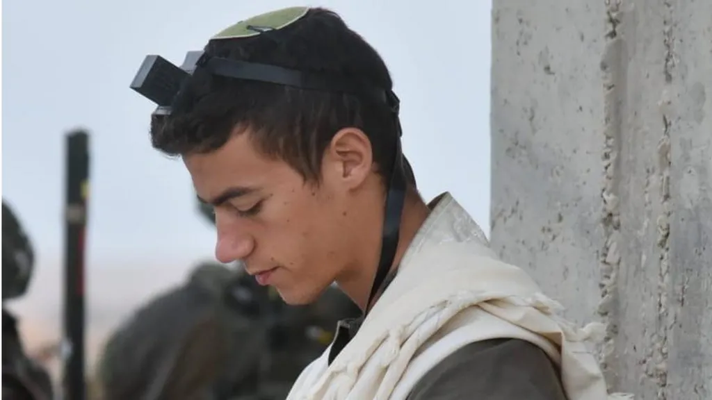 Yosef praying with tefillin