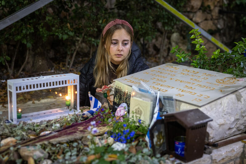 senai guedalia sits at grave of fallen soldier, her husband, yosef guedalia