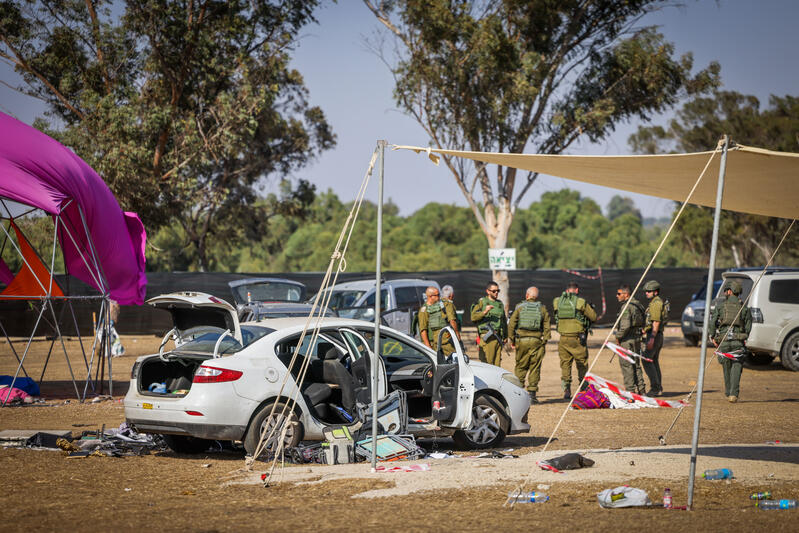 Damaged car and abandoned festival equipment at the Nova attack site near the Gaza border.