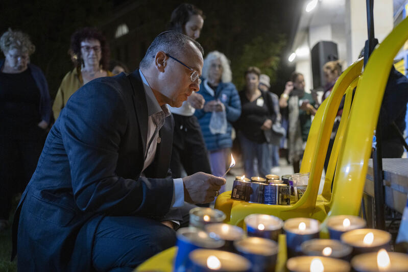 Sharon Sharabi lights a memorial candle for victims of the October 7 massacre during a ceremony in Jerusalem.
