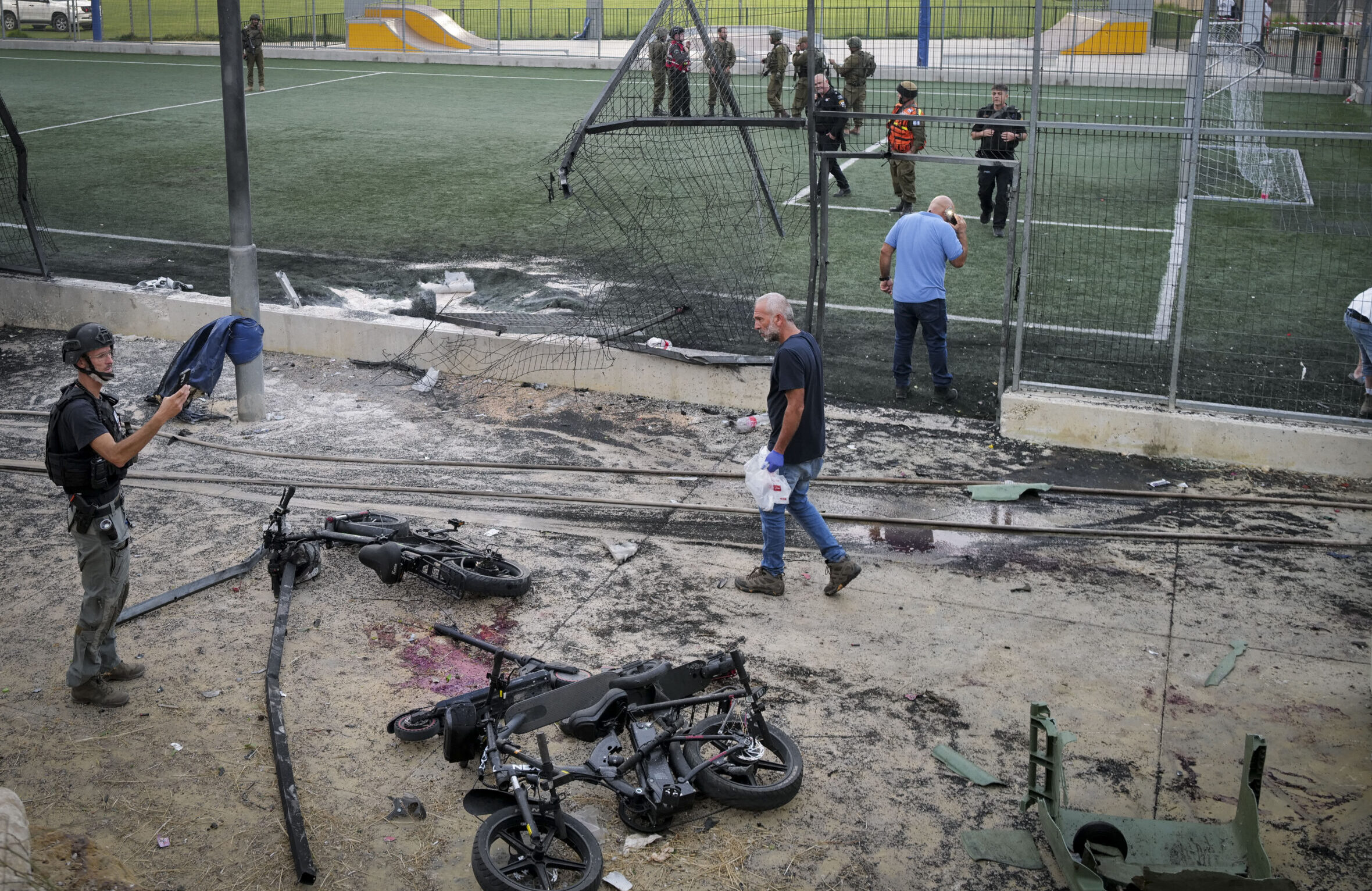 Israeli rescue forces stand at the site of a Hezbollah missile attack in Majdal Shams.