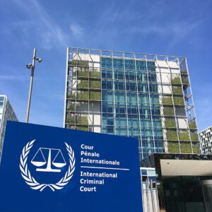 The International Criminal Court building in The Hague under a blue sky.
