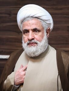 Naim Qassem wearing a white turban and clerical robes
