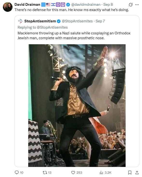 macklemore on stage with jewish prosthetic nose, and nazi salute