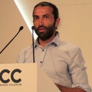 Mosab Hassan Yousef speaking at a podium.