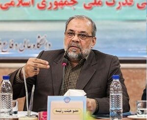 Mohammad Bagher Zolghadr speaking at a table during an official meeting.