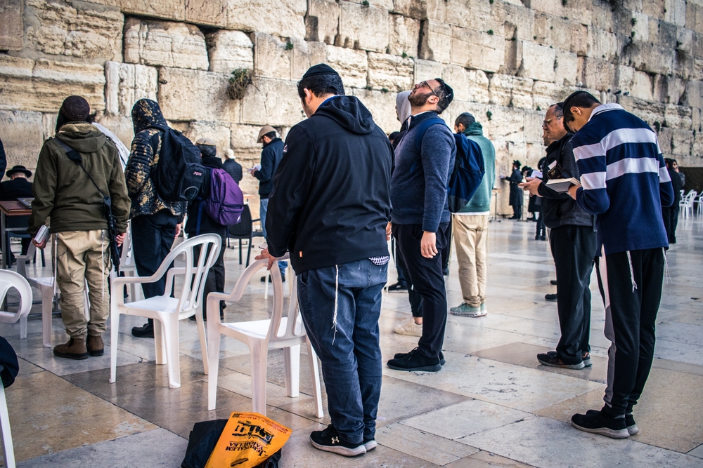 Men gathered in prayer at Western wall (kotel)