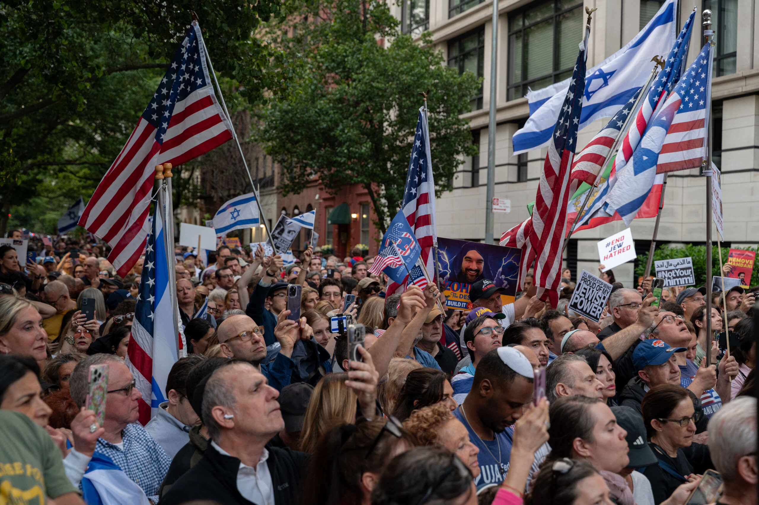 Jewish and pro-Israel activists waving Israeli and American flags during a protest against Zohran Mamdani in New York City.