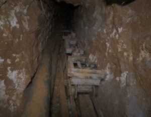 Underground Hezbollah tunnel infrastructure with wooden supports and a narrow passage.