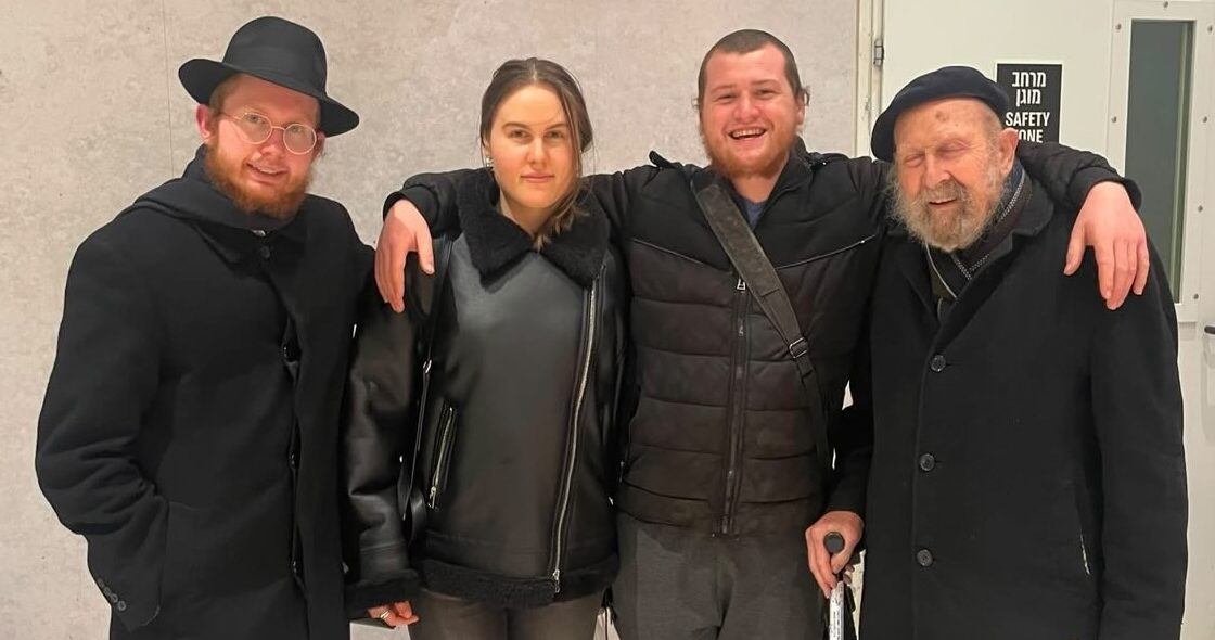 Moshe Shmuel Noll stands with family members.