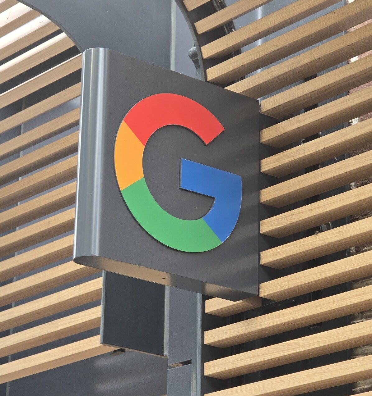 Google logo sign mounted inside an office building