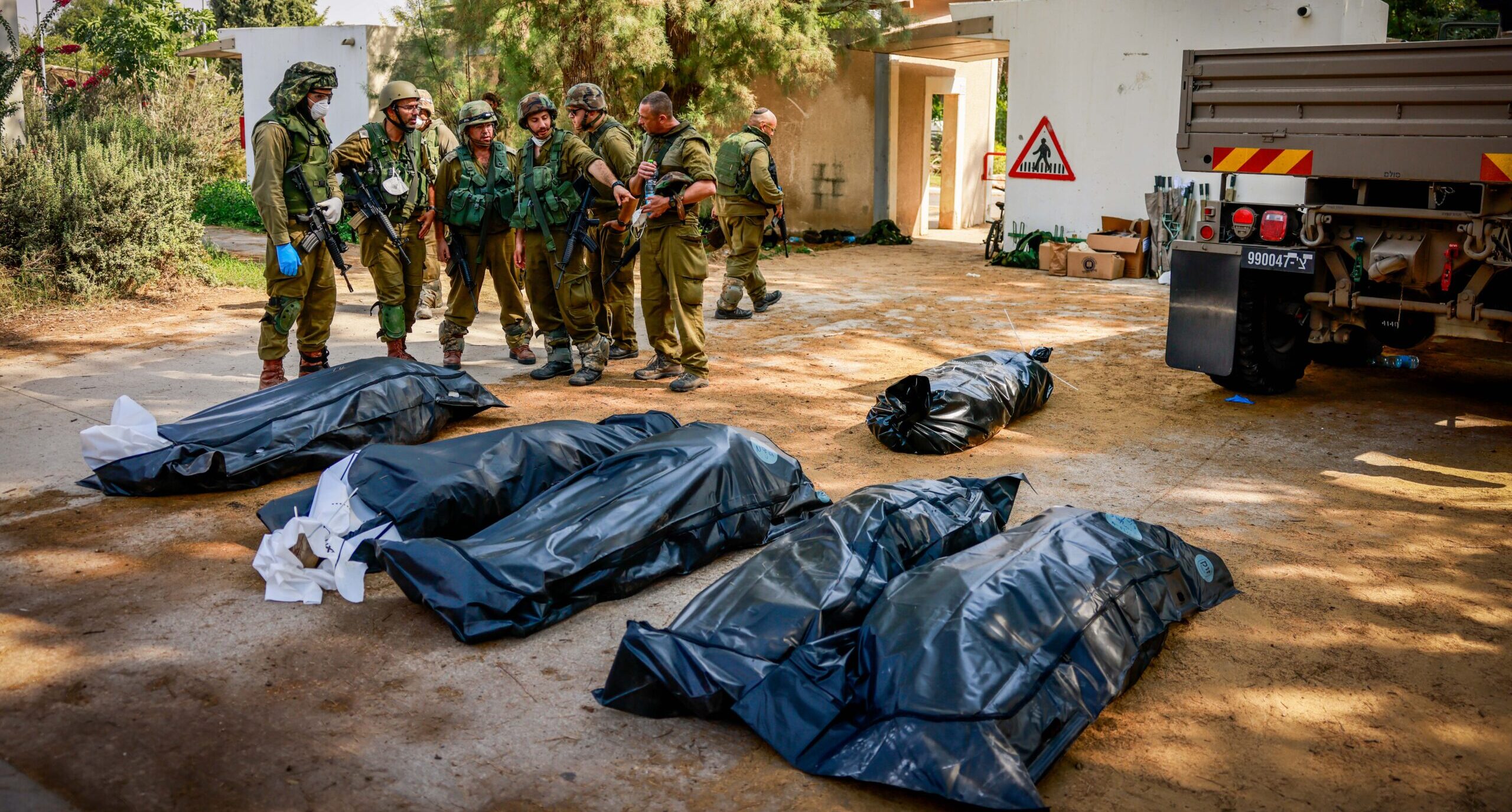 Israeli soldiers remove the bodies of civilians from Kibbutz Kfar Aza after the October 7 massacre.