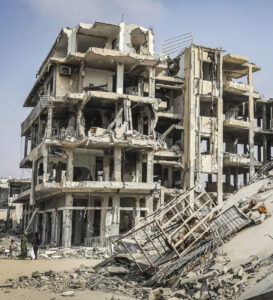 Palestinians walking past destroyed buildings in Khan Younis in the southern Gaza Strip.