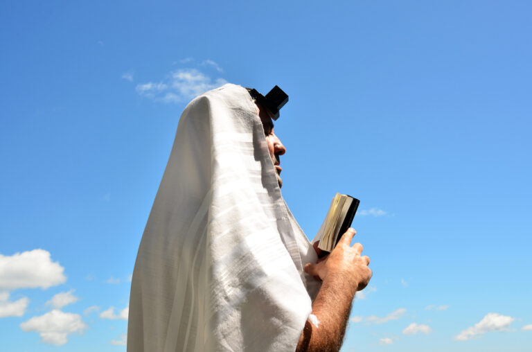 Jew praying with tefillin and tallit