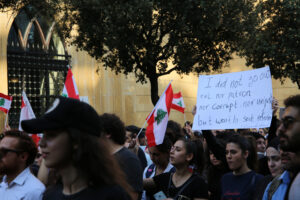 Lebanese protesters holding Lebanese flags during a demonstration in Beirut’s Martyrs’ Square.