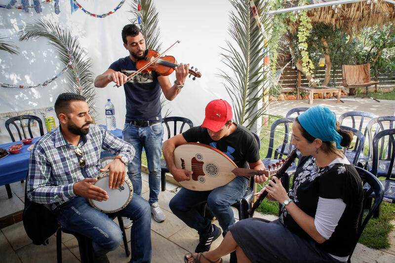 musical instruments being played in a sukkah