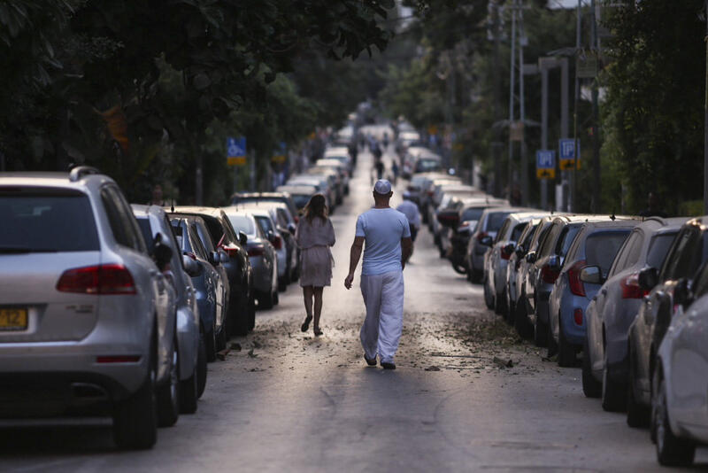 man walking in street in israel on the eve of yom kippur