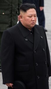 North Korean leader Kim Jong Un standing during a formal ceremony.