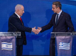 Benjamin Netanyahu, Nikos Christodoulides, and Kyriakos Mitsotakis stand at podiums during a joint press conference in Jerusalem.