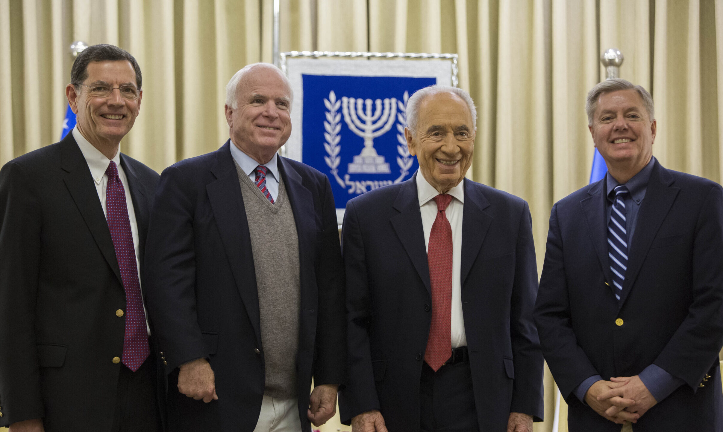 Lindsey Graham, Shimon Peres, John McCain and John Barrasso standing together in Jerusalem.