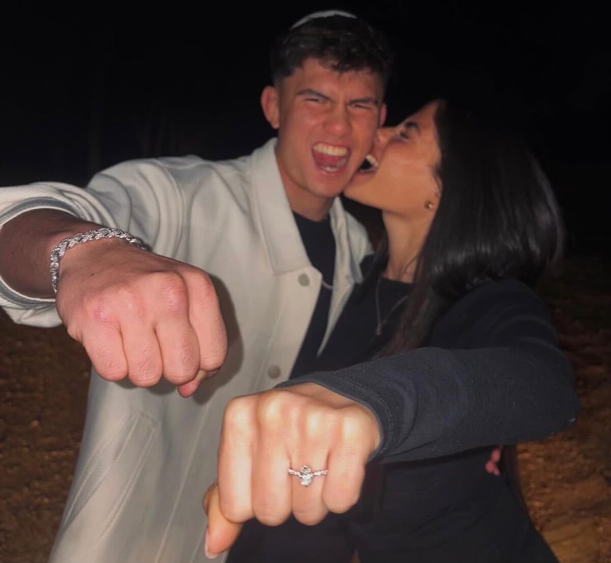 Ahavat Hashem Gordon and Oran Sara Levi posing together and showing an engagement ring.
