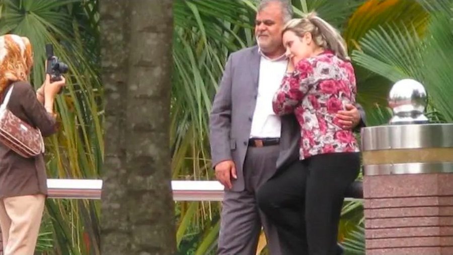 Rostam Ghasemi is seen embracing a woman in Malaysia in a leaked photo.