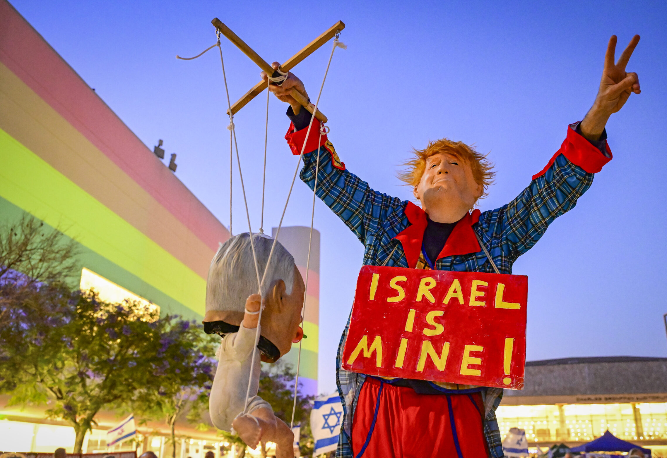 A demonstrator wearing a Trump-style costume protests against Prime Minister Benjamin Netanyahu in Tel Aviv.