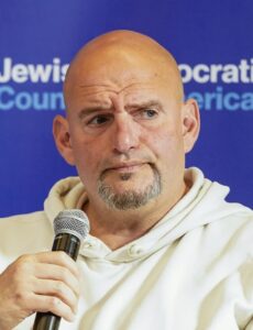 John Fetterman speaks into a microphone at the Jewish Democratic Council of America’s 2024 Leadership Summit.