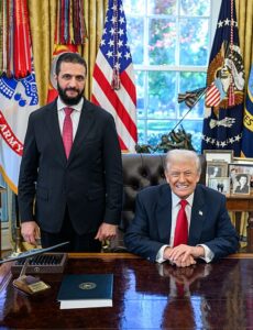 Syrian President Ahmed al-Sharaa standing beside U.S. President Donald Trump in the Oval Office.