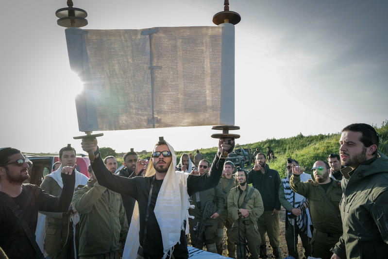 soldiers hold up torah scroll