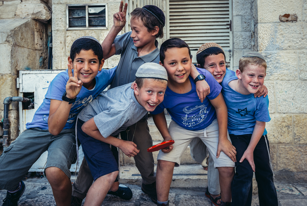 Boys with kippahs pose for a photo