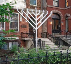 A Chabad House in Chicago with a large outdoor Chanukah menorah in front.