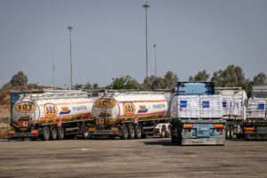 Trucks loaded with humanitarian aid waiting at the Kerem Shalom crossing before entering the Gaza Strip.