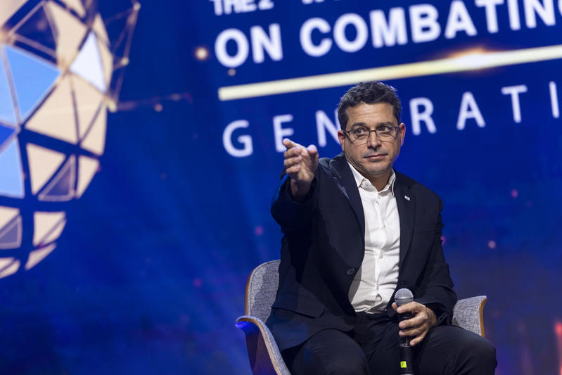 Amichai chickli on stage at conference