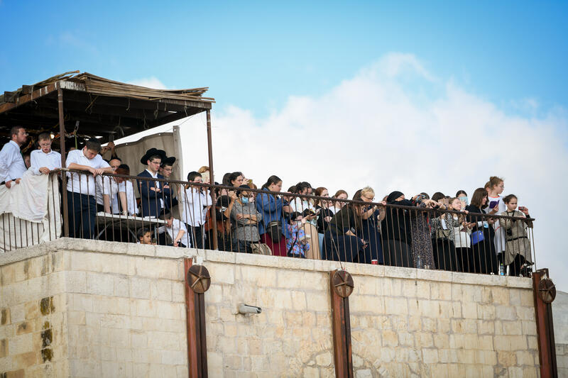 worshippers at an overlook across from western wall for priestly blessing