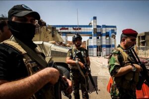 Iraqi soldiers stand armed outside a building in Fallujah.