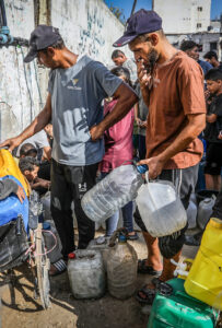 Palestinians filling water containers in Khan Younis in the southern Gaza Strip.