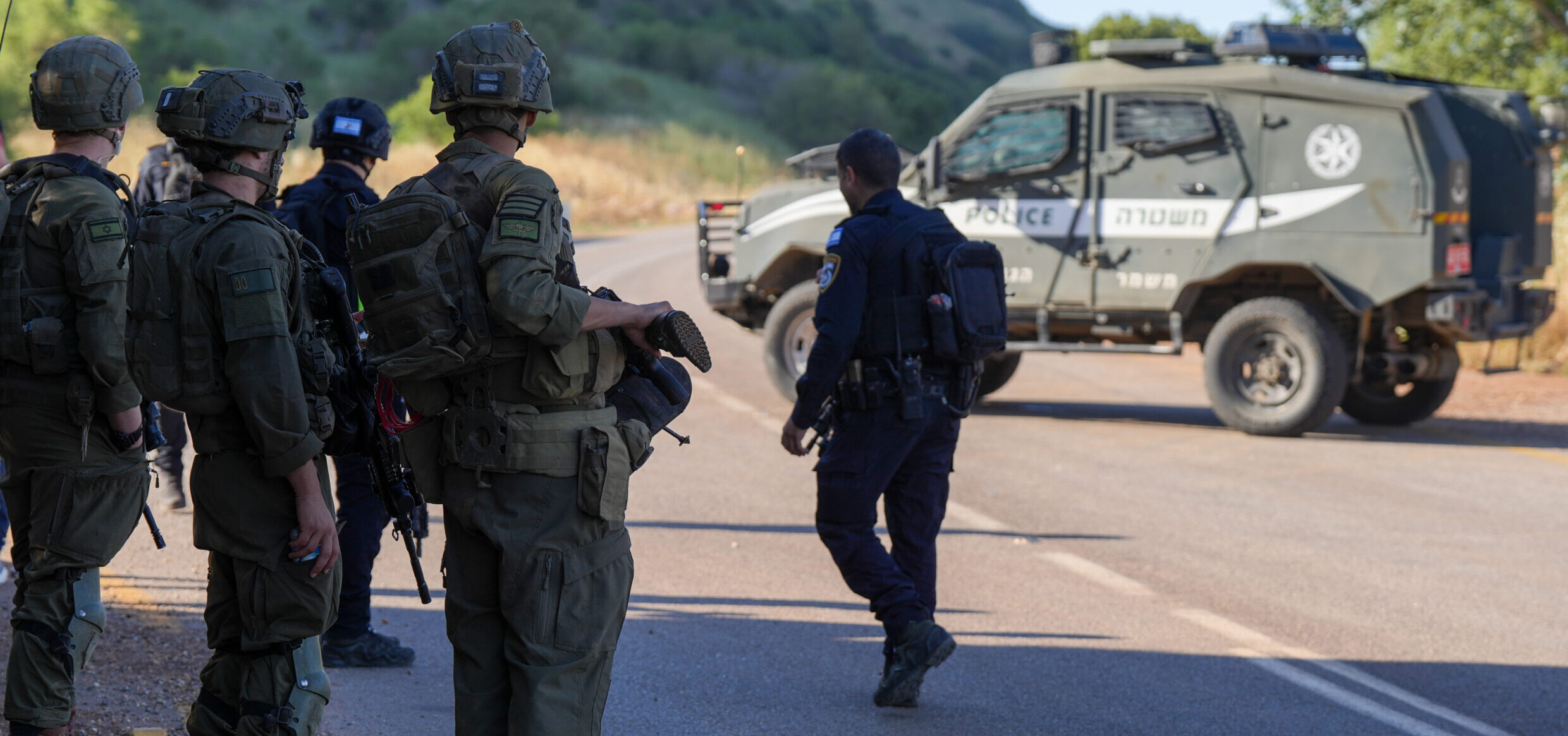 Israeli soldiers stand near a roadblock in the Ramim Ridge area of northern Israel.