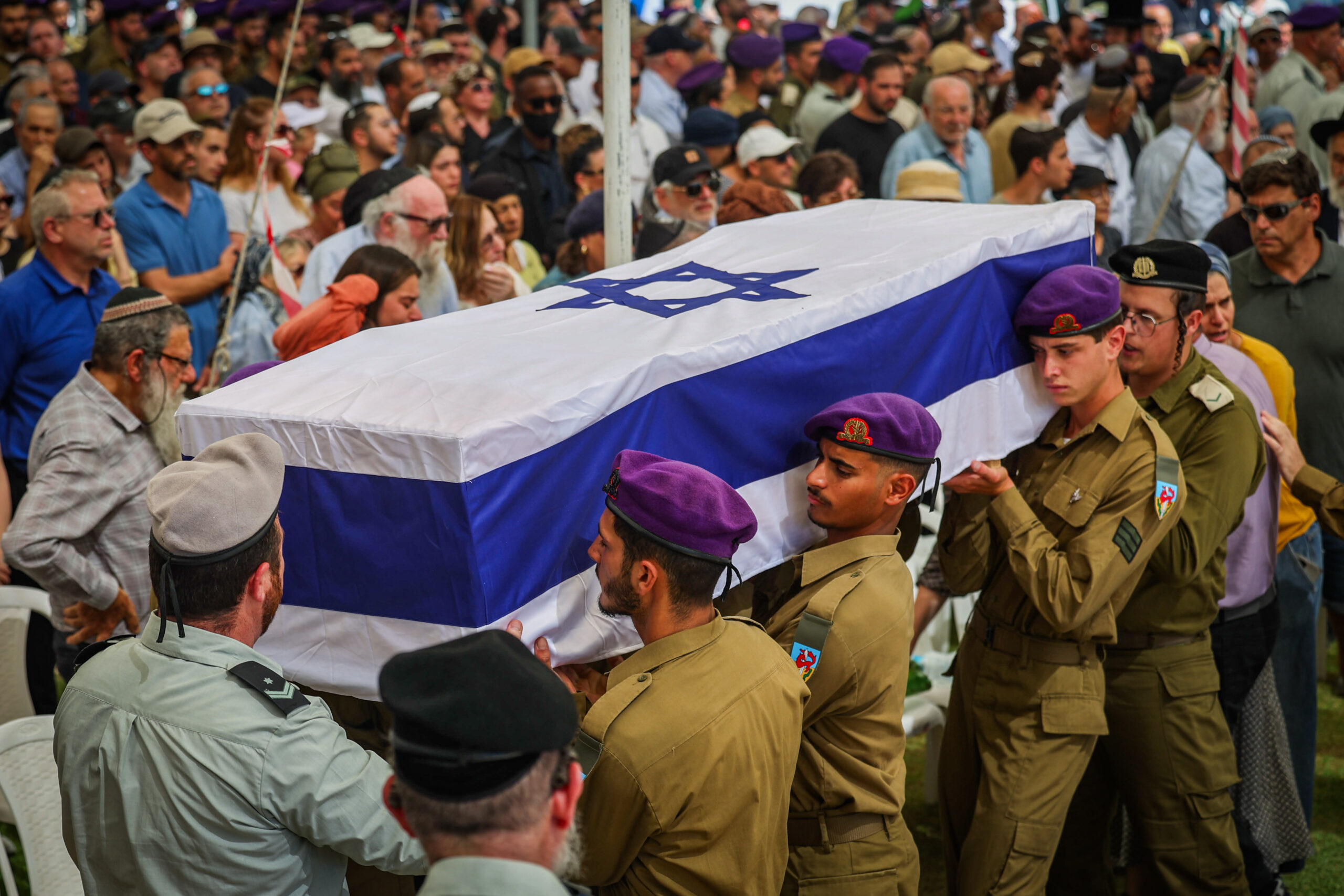IDF soldiers carry the Israeli flag-draped coffin of fallen soldier Ohad Yaari at his funeral.