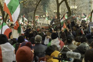 A large pro-Palestinian protest in Toronto with flags and anti-Israel signs.