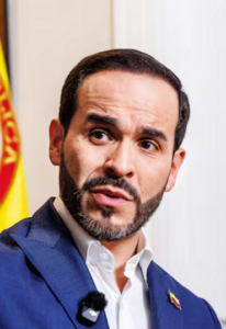Abelardo de la Espriella speaks during an interview with a Colombian flag behind him.