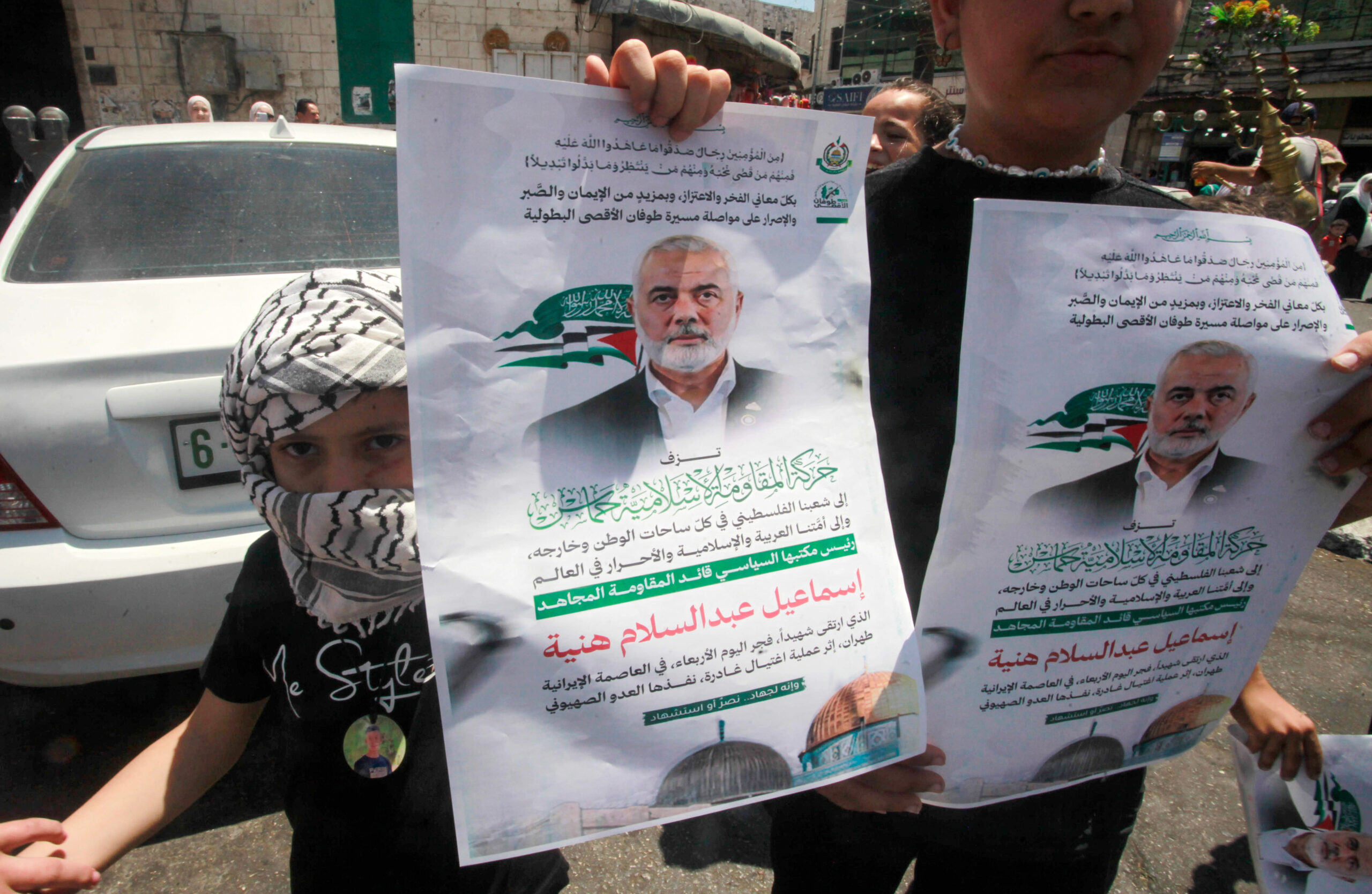 Palestinians hold posters of Hamas leader Ismail Haniyeh during a protest in Nablus.