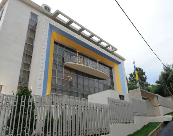 The Ukrainian Embassy building in Beirut with blue and yellow markings and a Ukrainian flag outside.