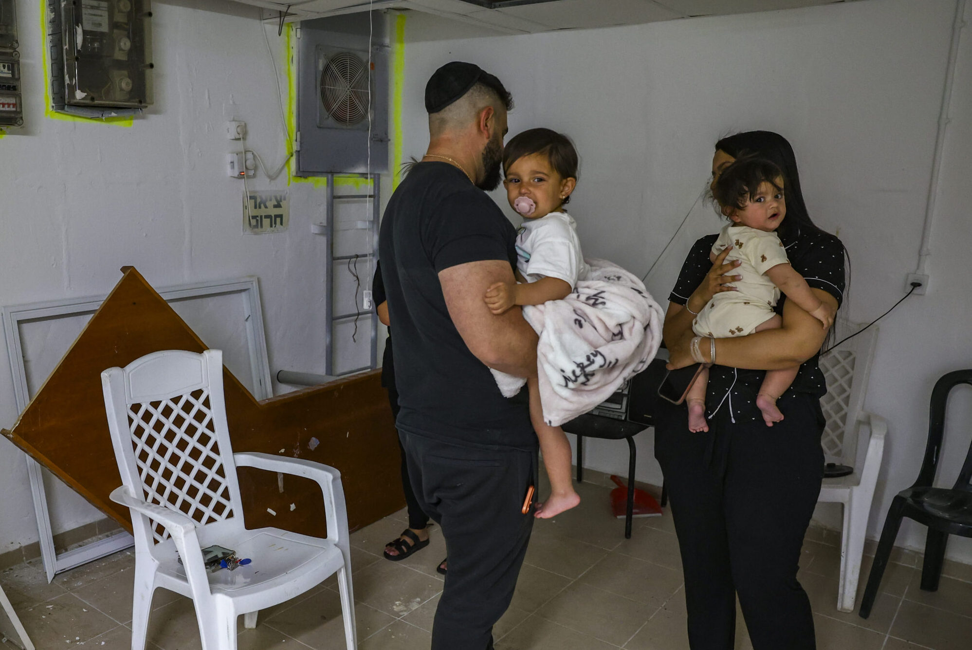 Israelis take cover in a public shelter in Tzfat during a missile siren.