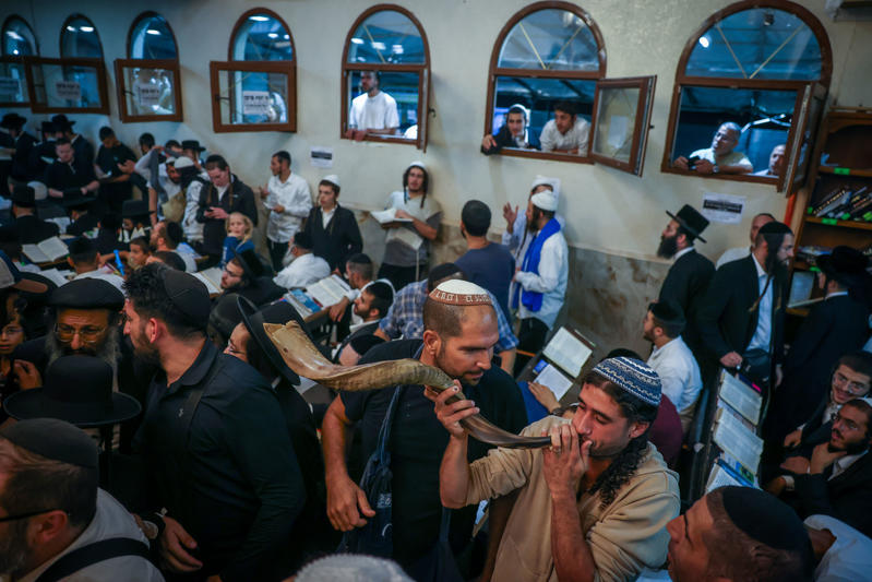 religious jew blows shofar in Uman, Ukraine at Rebbe Nachman's tomb