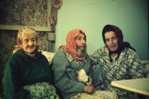 Mazal-Saada, Yosef and Margalit Zinati sitting together in their home in Peki'in.