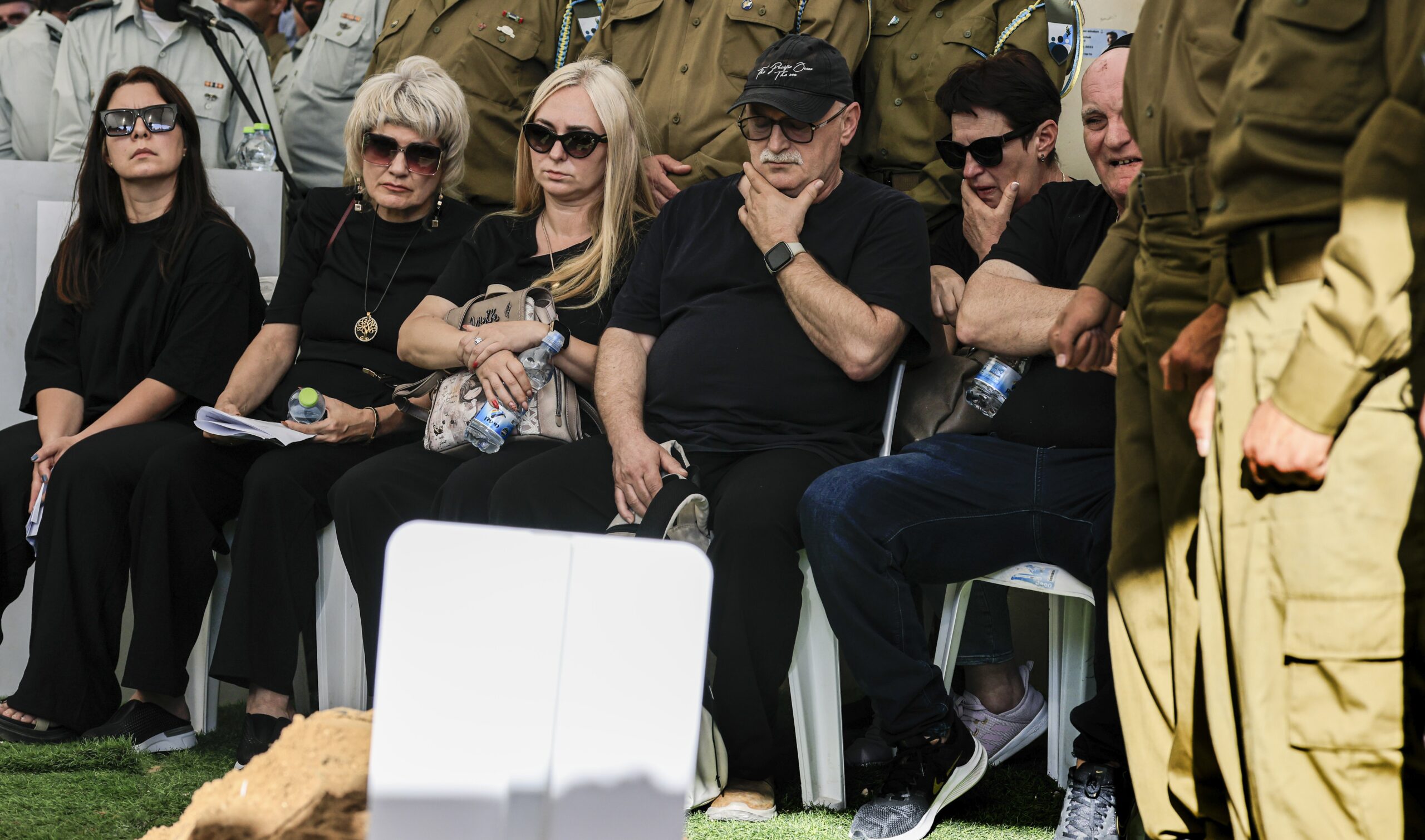 Mourners sit at the funeral of Staff Sgt. Michael Tyukin in Ashkelon.