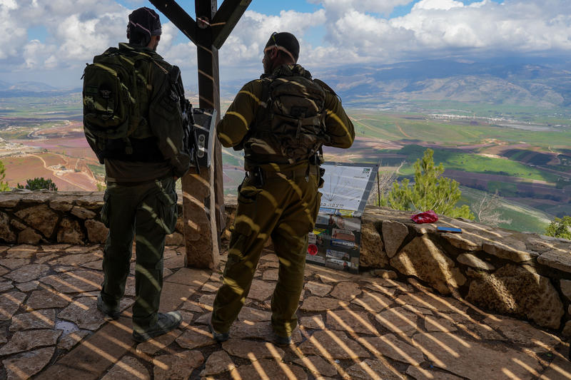 two israeli soldiers look out over Israel Lebanon border